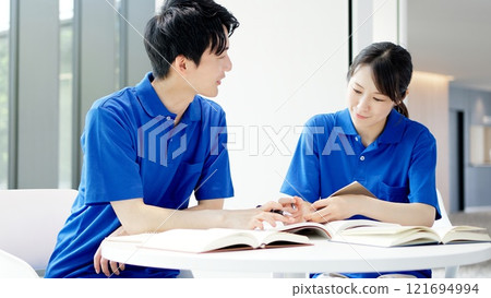 A caregiver studying for a qualification 121694994