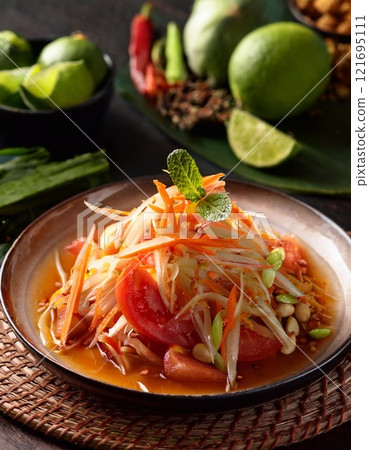Papaya Salad with salted egg in dish, spicy food style Papaya Salad with salted egg in dish, spicy food style 121695111