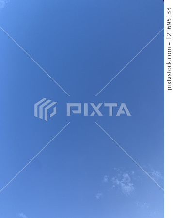 Bright blue sky with fluffy white clouds and sunlight Bright blue sky with fluffy white clouds and sunlight 121695133