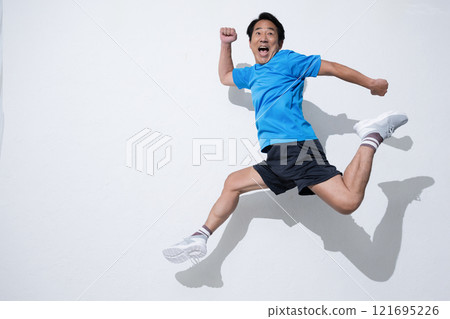 Image of an active man doing exercise, jumping on white background 121695226