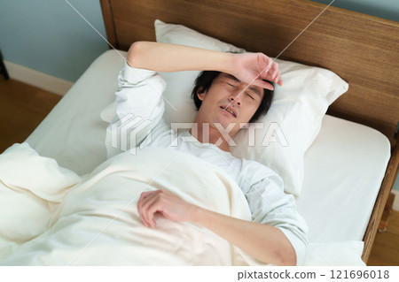 Middle-aged man sleeping 121696018