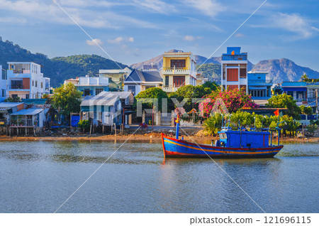 There are many traditional Vietnamese fishing boats and vessels in the bay on the river in Nha Trang There are many traditional Vietnamese fishing boats and vessels in the bay on the river in Nha Trang 121696115