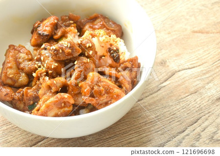 fried slice fermenting pork meat and mala sichuan sauce topping white sesame on plain rice in bowl 121696698