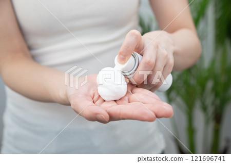 A woman's hand holding carbonated bubbles 121696741