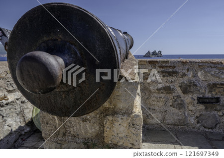 Montenegro, Petrovac, Kastio castle cannon in front of the Island of Nedjelja Sveta Montenegro, Petrovac, Kastio castle cannon in front of the Island of Nedjelja Sveta 121697349
