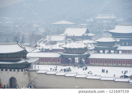 Snow falling in winter at Gyeongbokgung Palace and the sign says Gwanghwamun Gate, Seoul, South Korea. 121697539
