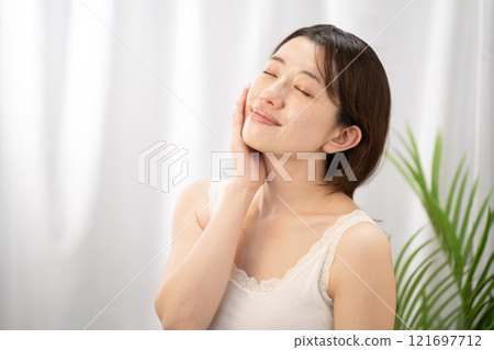 Smiling woman doing skin care 121697712