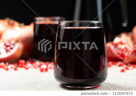 Natural pomegranate juice in a glass, close-up. Natural pomegranate juice in a glass, close-up. 121697972