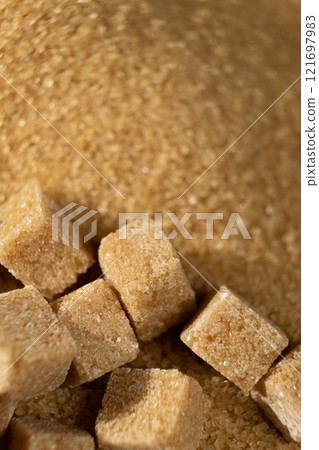 Brown cane unrefined demerara sugar in the form of crystals and cubes Brown cane unrefined demerara sugar in the form of crystals and cubes 121697983