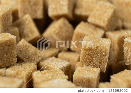 Macro cubes of brown cane unrefined demerara sugar. 121698002
