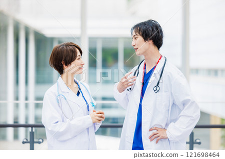 Male and female doctors working in a hospital 121698464