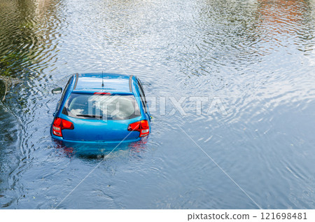 Blue car drown in water canal. Extreme accident vehicle sink in river pound lake, traffic incident 121698481
