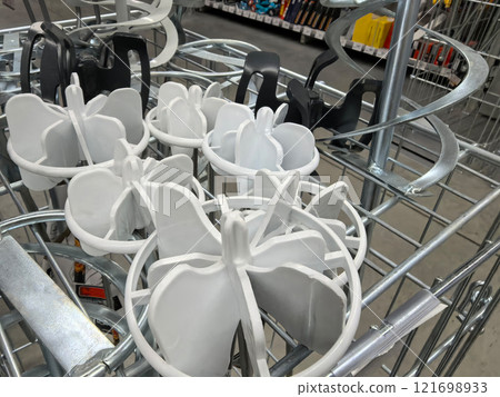 Display of plastic holders in a retail store aisle for shopping convenience Display of plastic holders in a retail store aisle for shopping convenience 121698933
