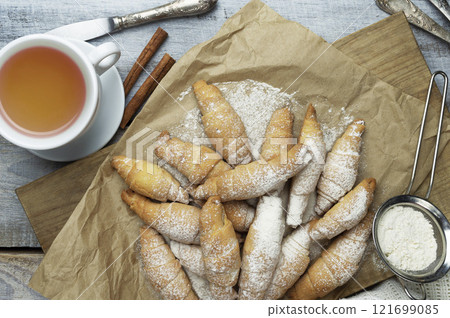 Fresh Baked Croissants or bagels. A pile of tasty crispy croissant on a wooden table. traditional homemade french pastries 121699085