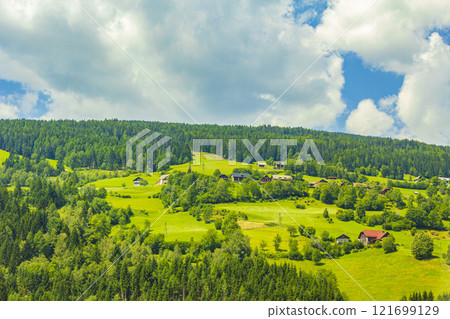 Wonderful wooded mountain alpine panorama with village and huts Austria. Wonderful wooded mountain alpine panorama with village and huts Austria. 121699129