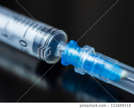 empty syringe positioned on a dark surface. High quality photo 121699318