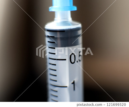 empty syringe positioned on a dark surface. High quality photo empty syringe positioned on a dark surface. High quality photo 121699320