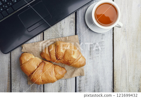 Freshly baked croissants on wooden background Warm Fresh Buttery Croissants and Rolls. food pastry for menu, cafe. 121699432