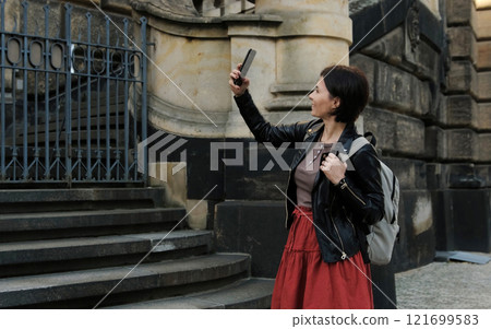 Attractive Woman Strolls Through Touristic Places Of Dresden, Capturing Photos Of Sightseeings 121699583
