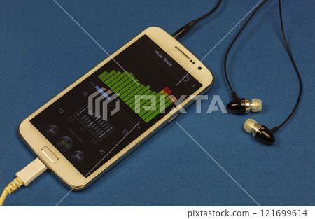 Music player equalizer on smartphone display and earphones, close-up Music player equalizer on smartphone display and earphones, close-up 121699614