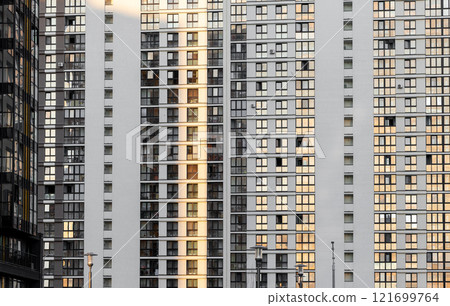 Urban building facade. Seamless pattern of a modern residential structure with rows of identical 121699764