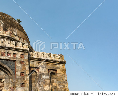 Ancient Indian building. Mughal stone architecture with decorative carvings, old dome. Historical Ancient Indian building. Mughal stone architecture with decorative carvings, old dome. Historical 121699823