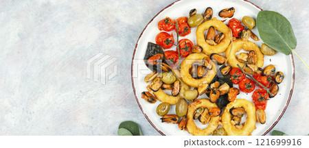 Grilled mussels with herbs and squid rings. Grilled mussels with herbs and squid rings. 121699916