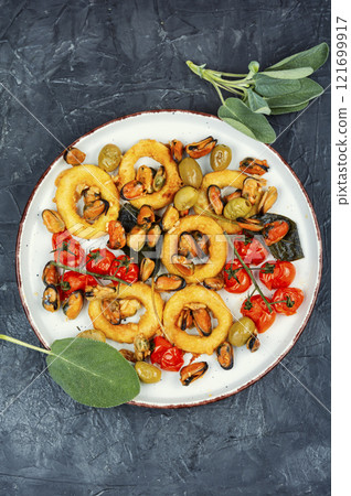 Steamed mussels and roasted squid rings. Steamed mussels and roasted squid rings. 121699917