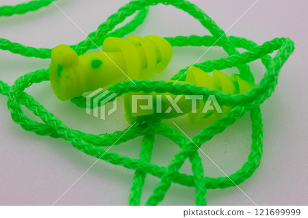 Bright Green rubber earplugs on white background safety 121699999