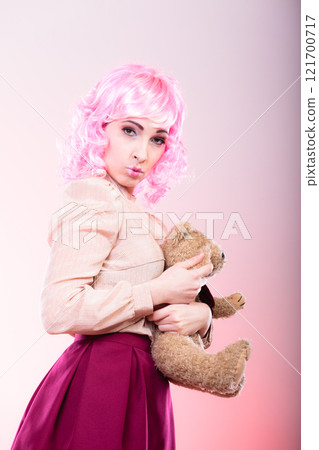 childlike woman with teddy bear toy childlike woman with teddy bear toy 121700717