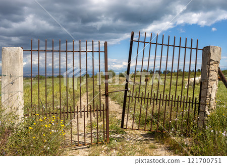 Dusty road and an old gate, Sicily, Italy Dusty road and an old gate, Sicily, Italy 121700751