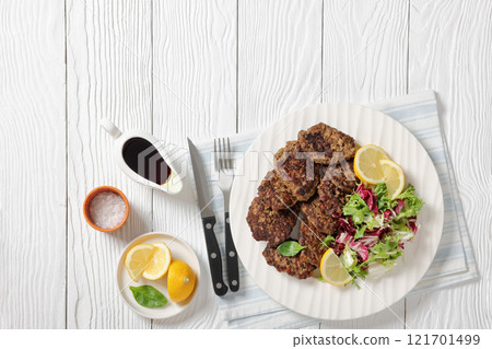 pork liver patties with fresh salad and lemon pork liver patties with fresh salad and lemon 121701499