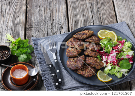 pork liver patties with fresh salad and lemon pork liver patties with fresh salad and lemon 121701507