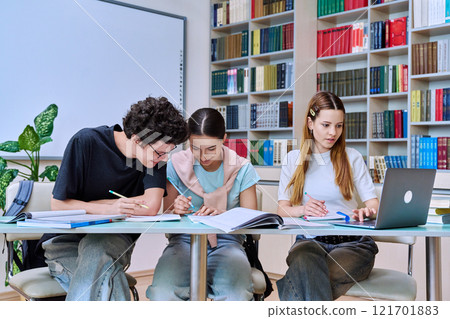 Group of high school students studying in library classroom 121701883