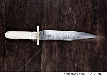 Old west bowie knife on wooden deck 121702019