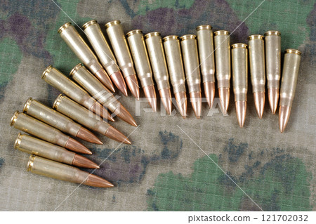 kalashnikov ak47 cartridges on camouflage uniform 121702032