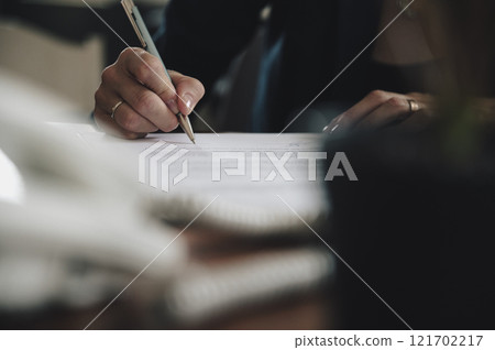 Low angle view of a businesswoman signing a contract 121702217