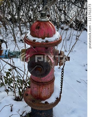 A rusty and dilapidated fire hydrant in a corner of town A rusty and dilapidated fire hydrant in a corner of town 121702273