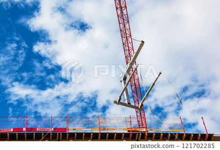 Crane and crane hook close up against blue sky 121702285