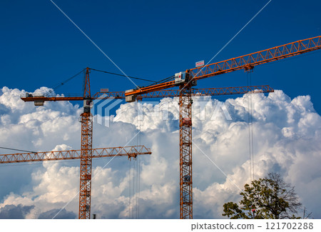 Crane and crane hook close up against blue sky 121702288