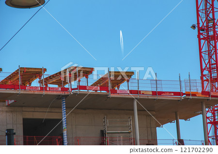 Crane and construction site against blue sky Crane and construction site against blue sky 121702290