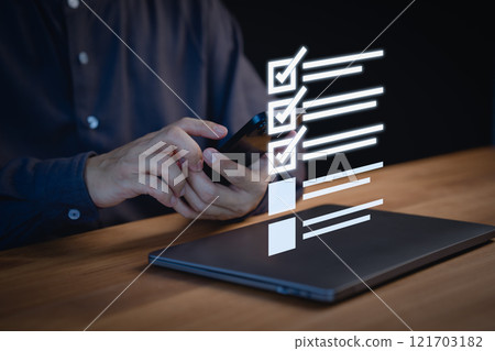 Person using a smartphone to check items off a digital checklist, productivity, and organization. Concept emphasizes the use of technology for staying organized and completing tasks efficiently. 121703182