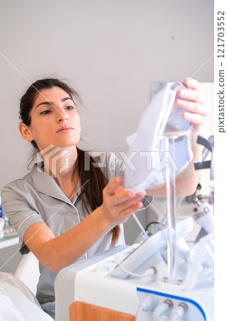 Female cosmetologist using modern hydrafacial Female cosmetologist using modern hydrafacial 121703552