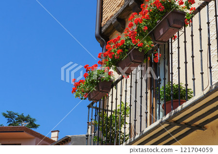 The contrast between the red flowers planted on the balcony and the deep blue sky of midsummer 121704059