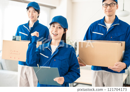 Moving support team carrying cardboard boxes in an apartment building Moving support team carrying cardboard boxes in an apartment building 121704173
