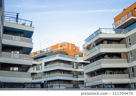 Multi-story gray buildings with wide continuous balconies and orange roofs have been built Multi-story gray buildings with wide continuous balconies and orange roofs have been built 121704479