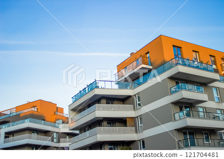 Multi-story gray buildings with wide continuous balconies and orange roofs have been built  121704481