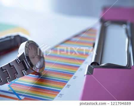 Binder, graph and watch on the table Binder, graph and watch on the table 121704889