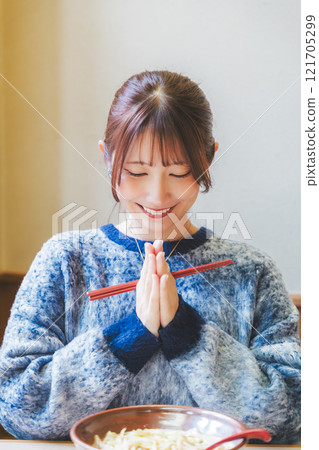 Young woman eating ramen after saying itadakimasu Young woman eating ramen after saying itadakimasu 121705299