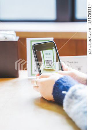 Young woman ordering via QR code 121705314